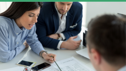 2 people explaining paperwork to a third