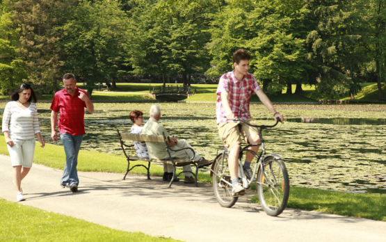 people cycling walking and sitting in a aprk