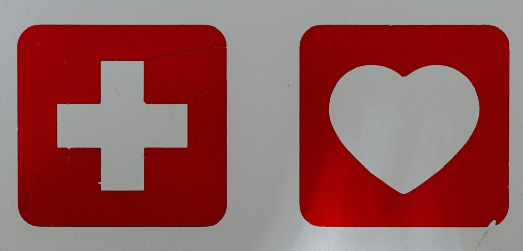 Two red first aid symbols on a white background
