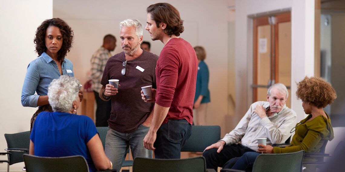 Small, informal group of people of all ages, talking in small groups and pairs