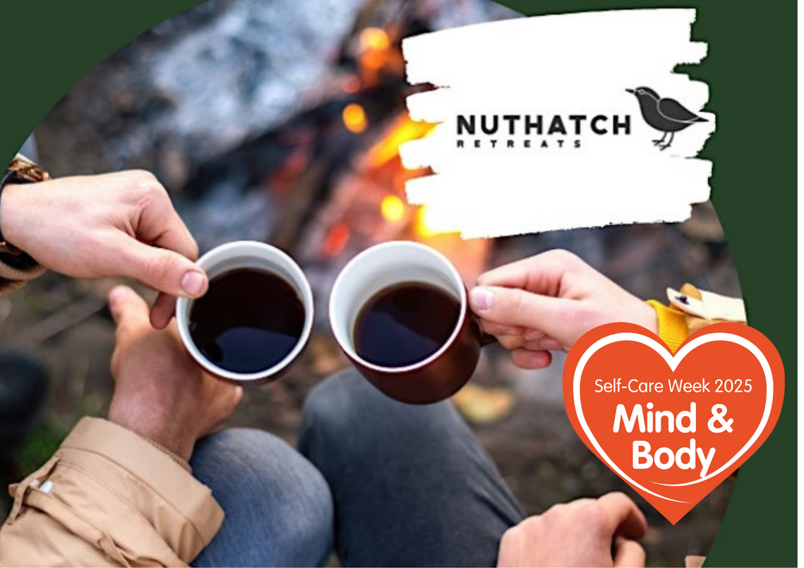 2 people holdiung mugs with a campfire in the background