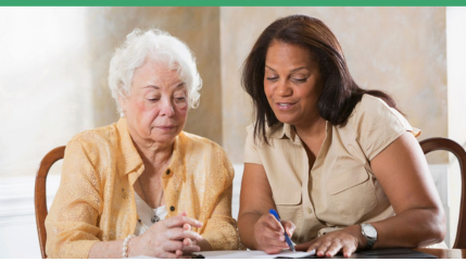 one woman explaining some papaerwork to another, older woman