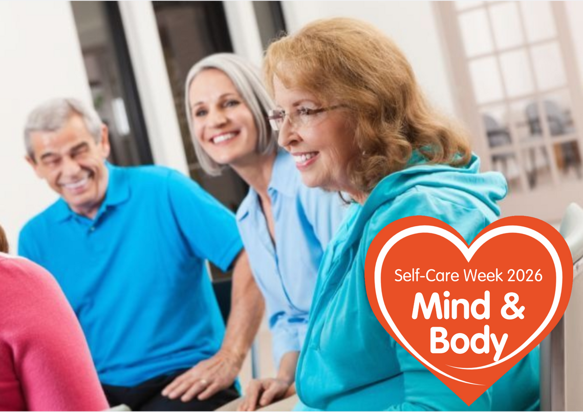 small group of older adults chatting indoors