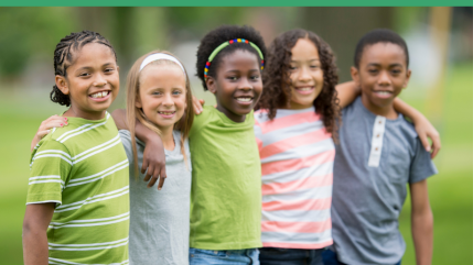 small group of children standing together, arms around shoulders, outside