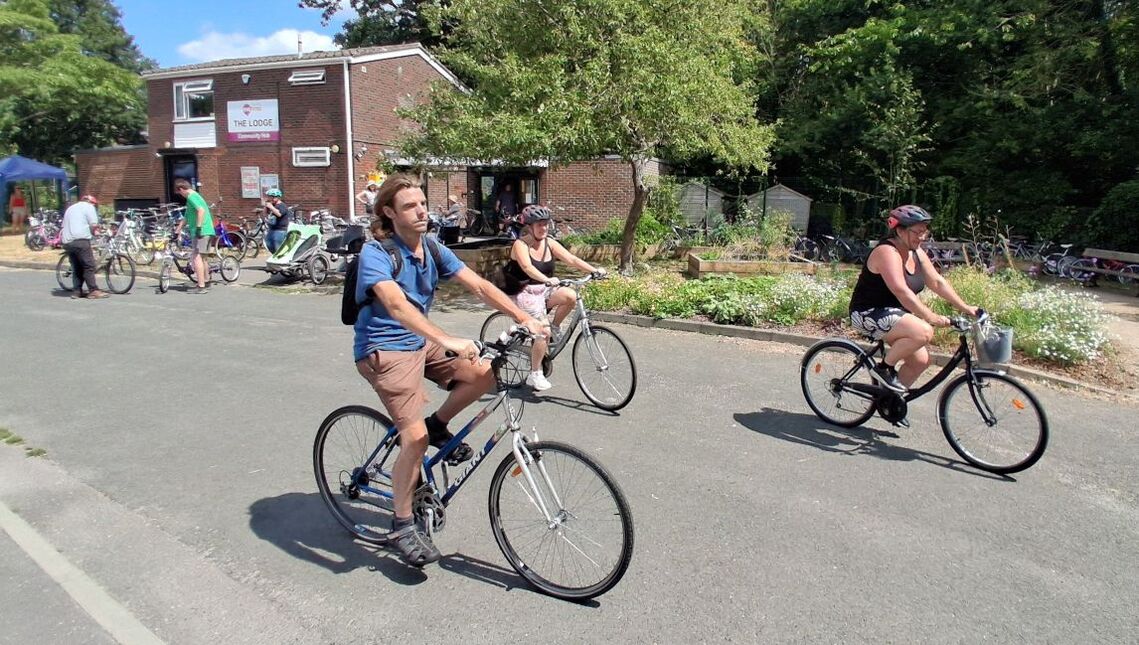 small group of cyclists setting off in the park